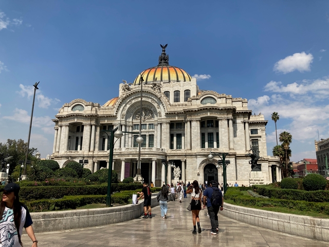       Palacio de Bellas Artes with people strolling around.
  