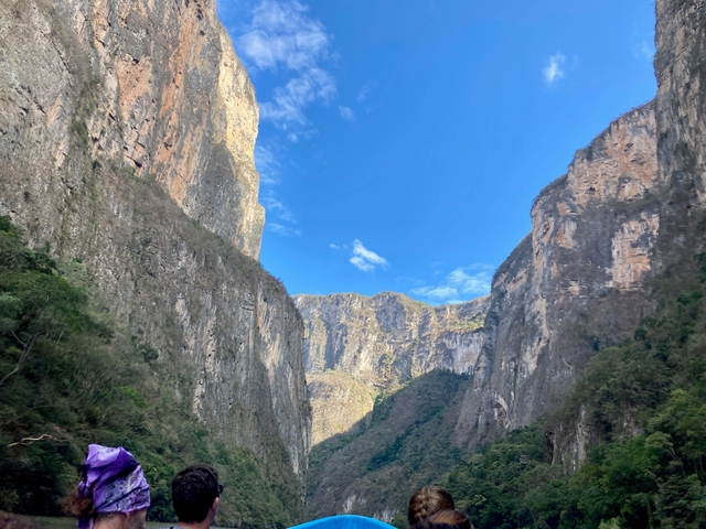 Tall canyon cliffs under a blue sky.