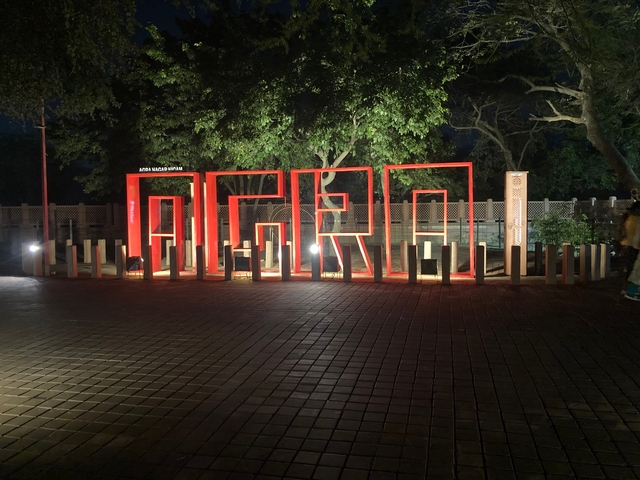 Large red letters spelling 'AGRA' in a park setting.