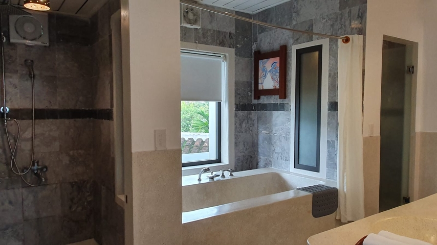       Modern bathroom with a bathtub and a window view.
  