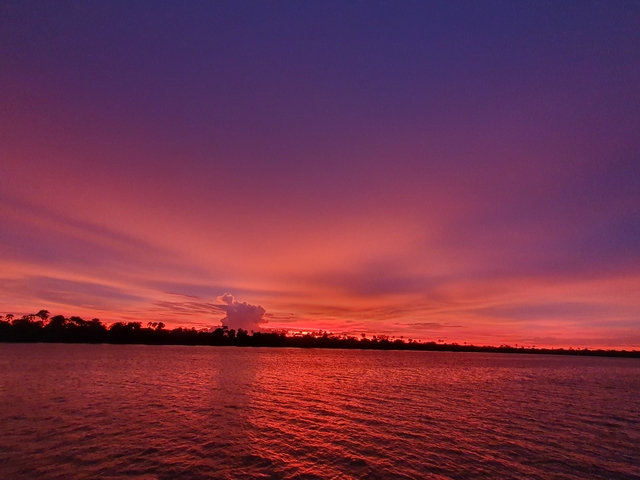 A vibrant sunset over a body of water.