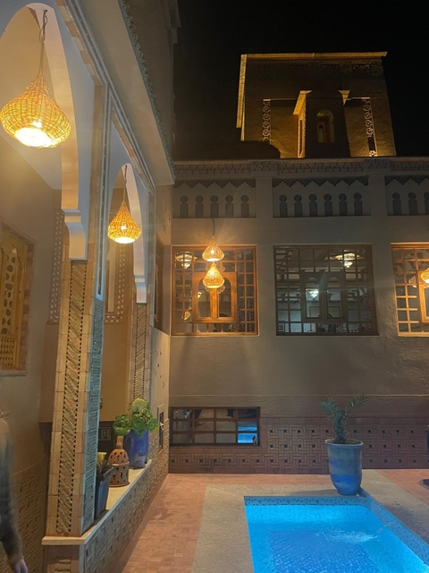       An indoor view of a well-lit area with hanging lamps.
  