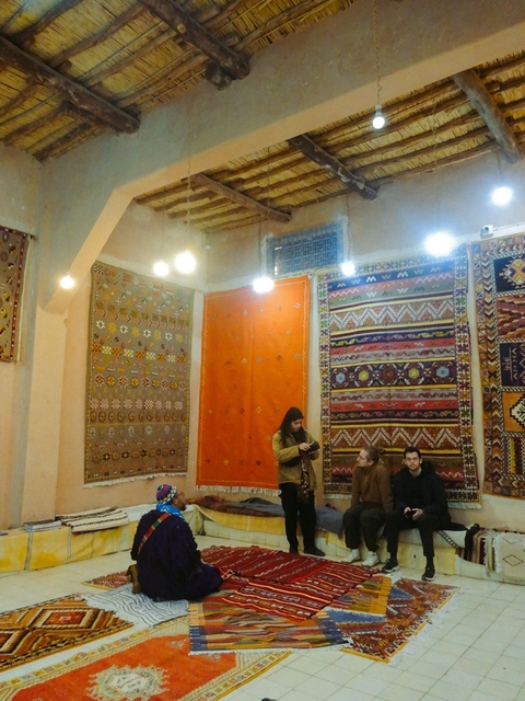       A shop with colorful traditional rugs on display.
  