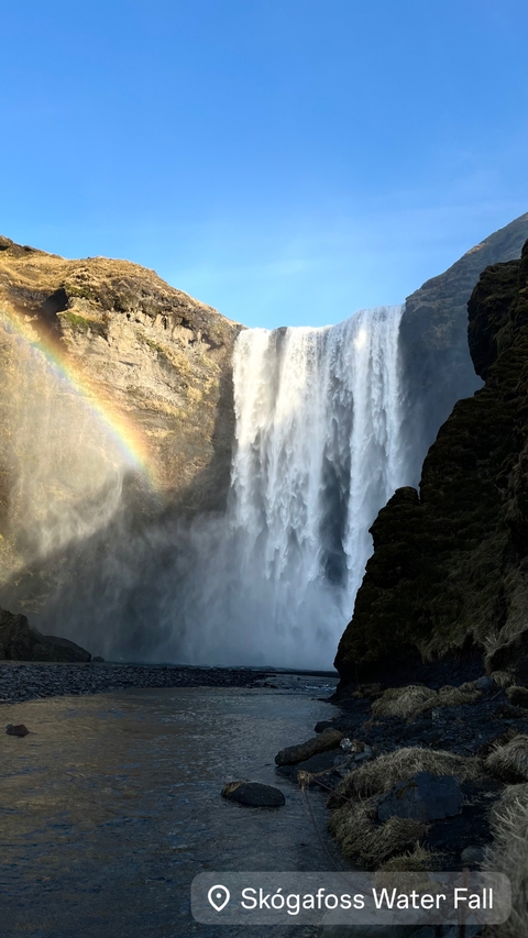       Powerful waterfall with rainbow in the spray.
  