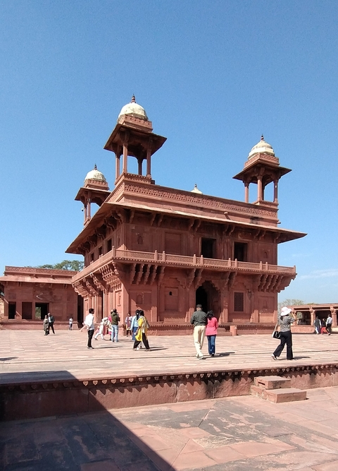 Fatehpur Sikri building with tourists exploring.