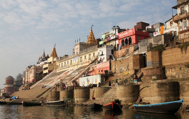 Colorful buildings and steps along a riverbank.