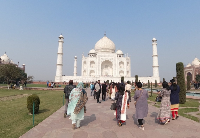 Visitors walking towards the iconic Taj Mahal.