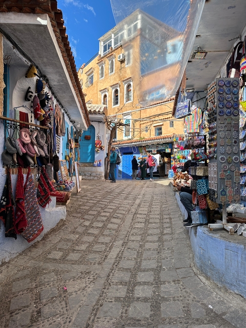 Colorful street market with various items on display.