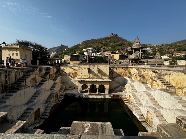 Historic stepwell with visitors exploring.