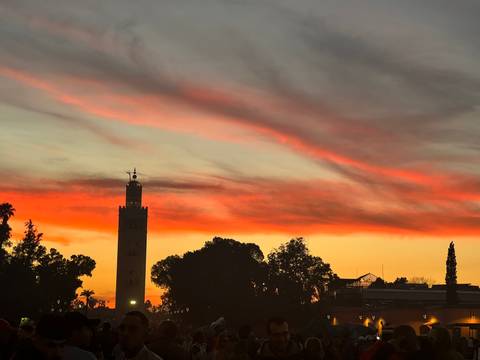 A stunning sunset with a silhouette of a tall tower against colorful skies.