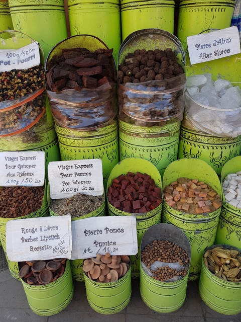 Various spices and herbal goods displayed in a market.