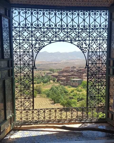 A scenic village view from a beautifully designed window frame.