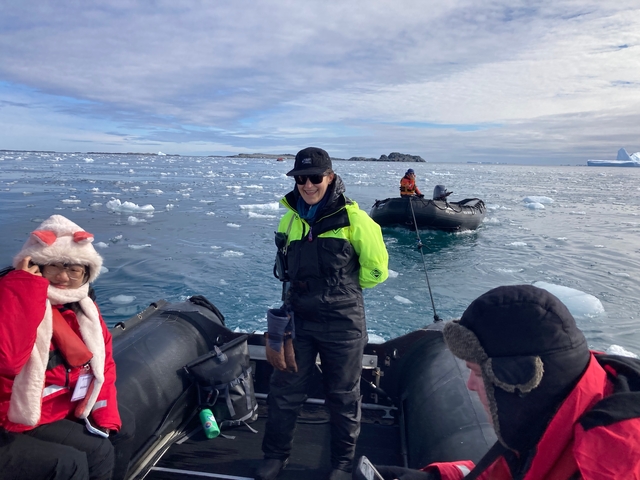 People on inflatable boats in icy water, Antarctica.