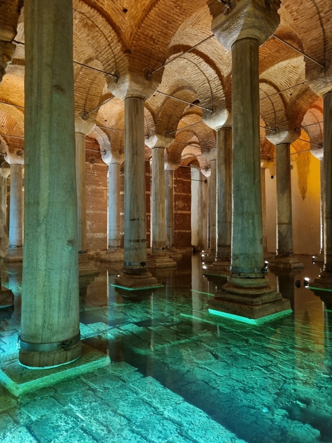       Columns with lighting and reflections in a historic architecture setting.
  