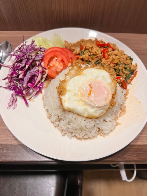       Close-up of a plate with rice, fried egg, and vegetables.
  