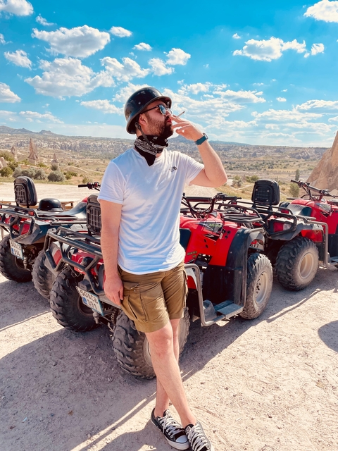       Person with ATVs in a rocky terrain.
  