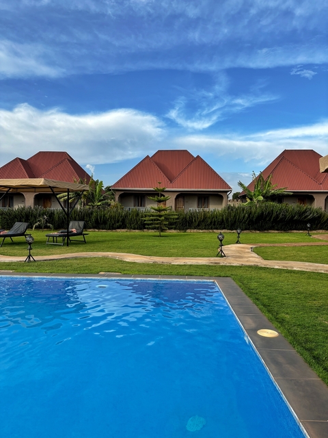 Cottages by a pool with red roofs.