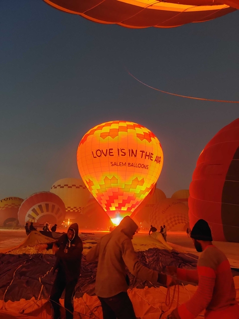       Hot air balloons illuminated at night.
  