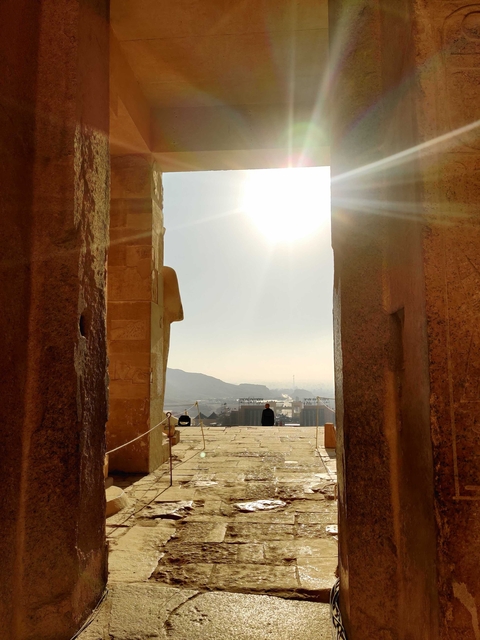 Person standing at the entrance of an ancient structure.