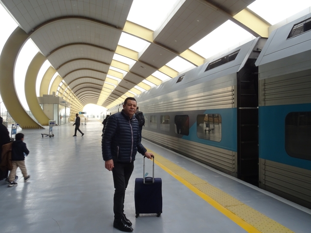       Man standing at a modern train station
  