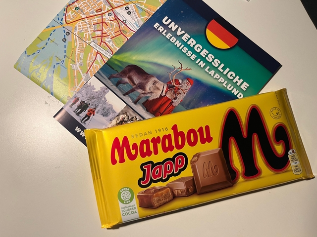 Chocolate bar and maps on a table.