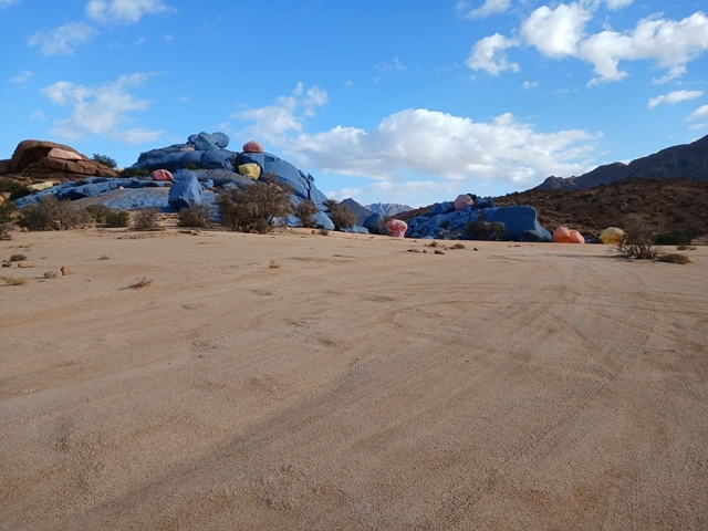 Desert landscape with painted rocks of various colors.