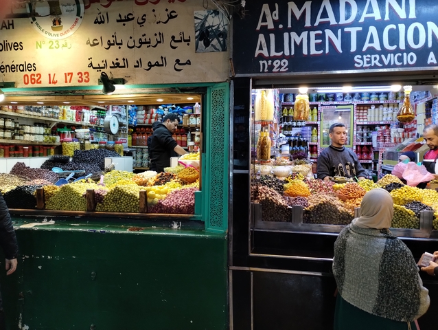 Busy market with diverse goods being sold.