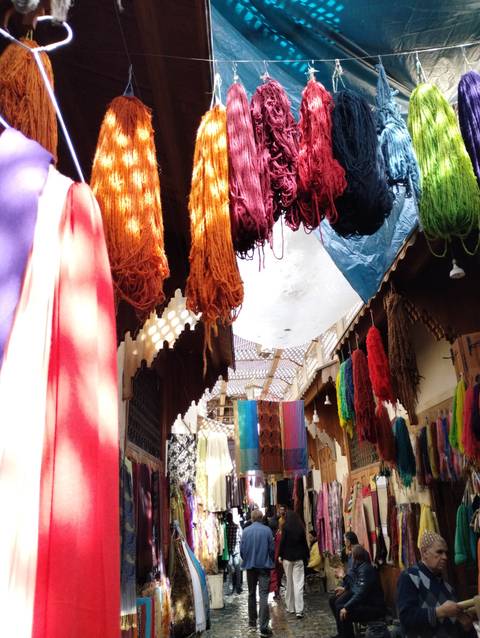 Hanging dyed yarns and fabrics in various colors.