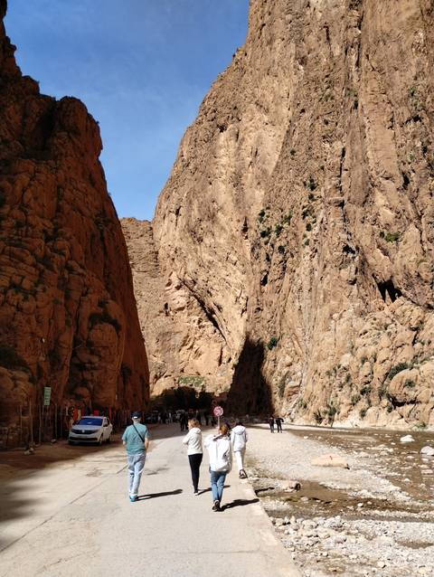       Tall rocky cliffs with a narrow gorge.
  