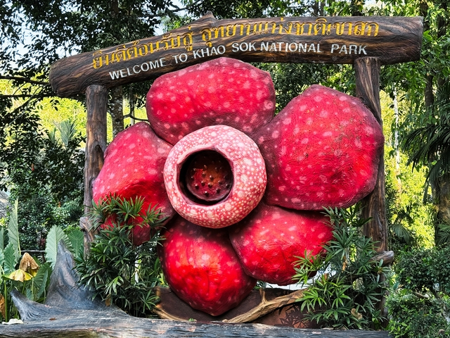       Large decorative flower statue at Khao Sok National Park entrance.
  