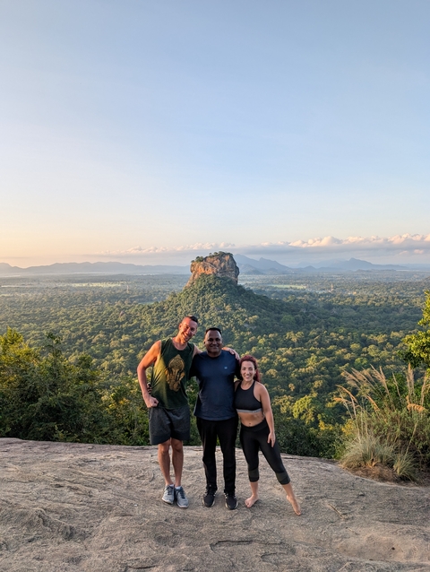 Group posing with a view of Sigiriya in the background.
