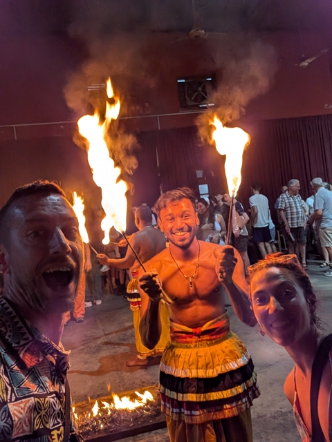       Group of people with fire torches during a performance.
  