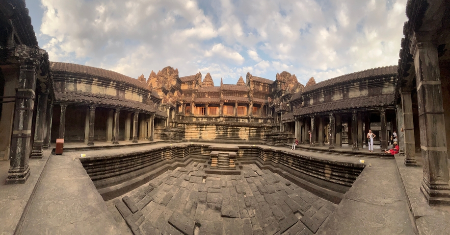       The interior of an ancient temple with elaborately carved walls.
  