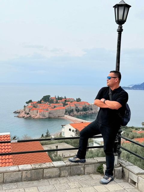       Tourist overlooking a coastal islet.
  