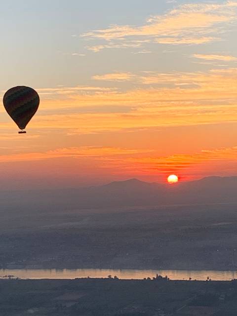       Hot air balloon in the sky during sunset.
  