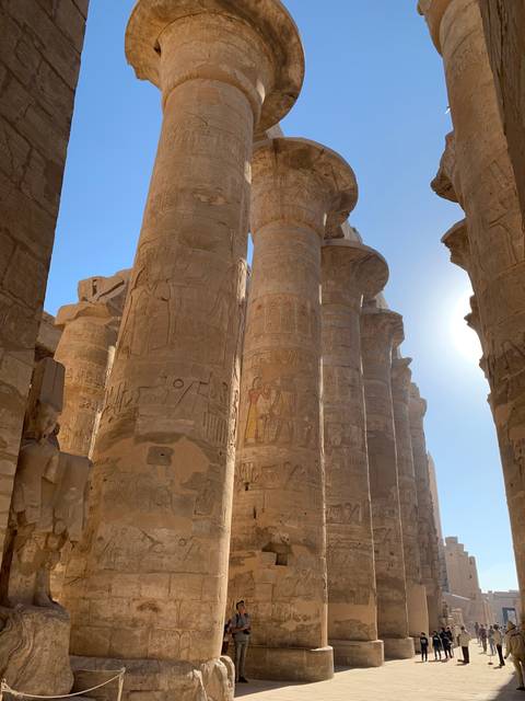       Temple columns with sunlight filtering through.
  