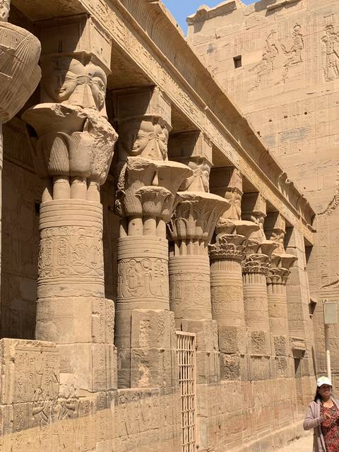       Ornate temple columns with ancient carvings.
  