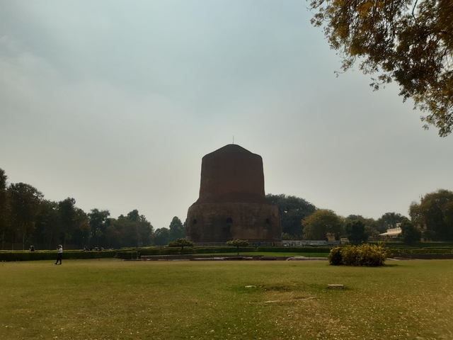 A large stone monument in a park setting.