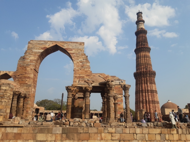       Ancient ruins with a towering minaret in the background.
  