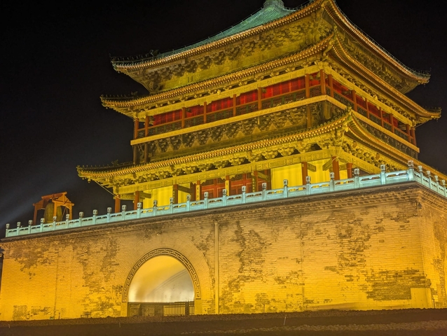 Elaborately decorated Chinese tower lit up at night.