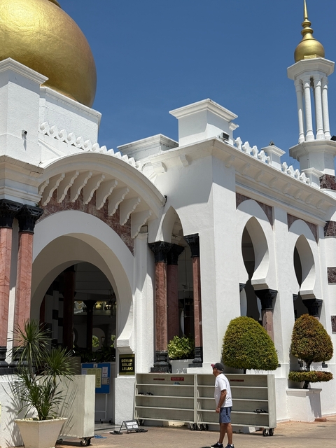 White building with arches and intricate detailing.