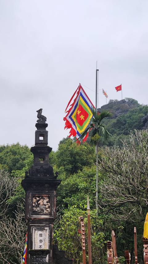 Colorful flag with ancient monument in the background.