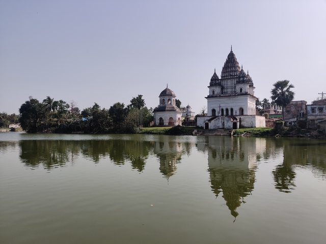 Temples by a lake with clear reflections in the water.