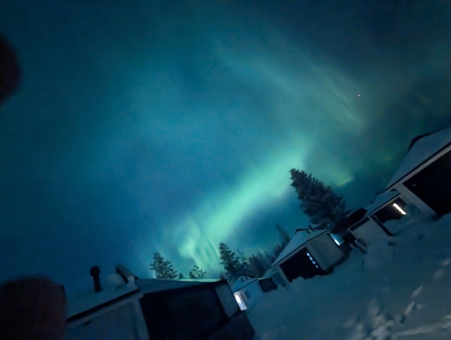 Aurora Borealis over a snowy landscape.