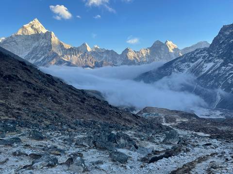 A panoramic view of mountains and a cloud-filled valley.