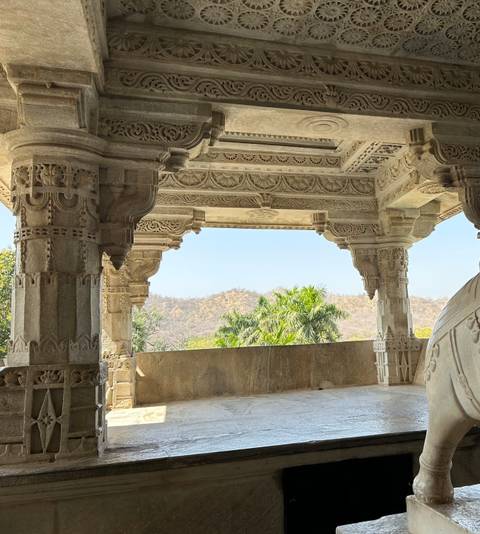 A stone veranda with mountainous landscape view.