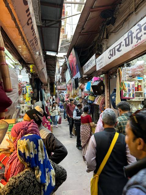 A bustling market scene with people shopping.