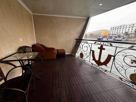       A river view from a balcony with furniture.
  