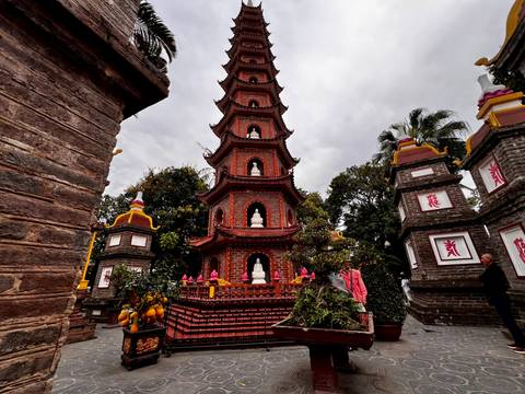       A pagoda with intricate architecture in a garden setting.
  