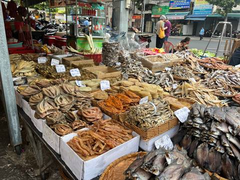       A market stall filled with various types of dried fish.
  